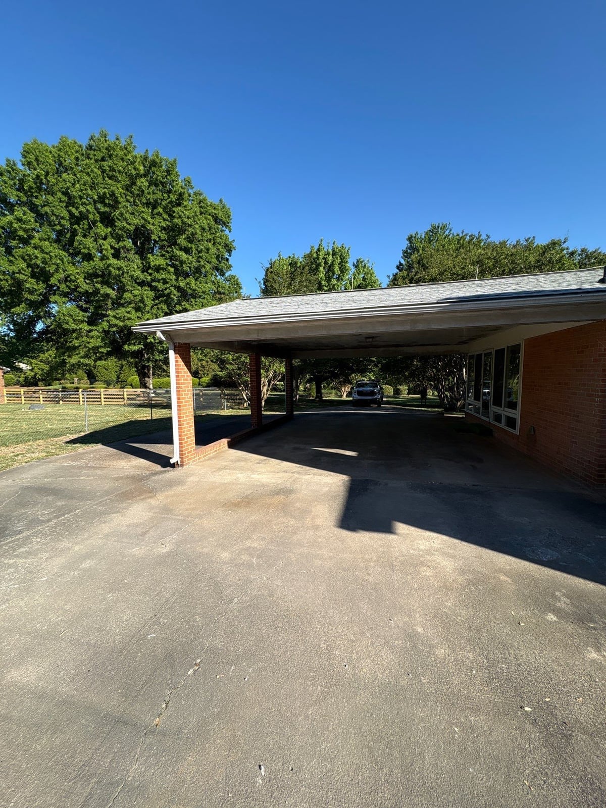 Exterior carport ceiling and concrete driveway pressure washing