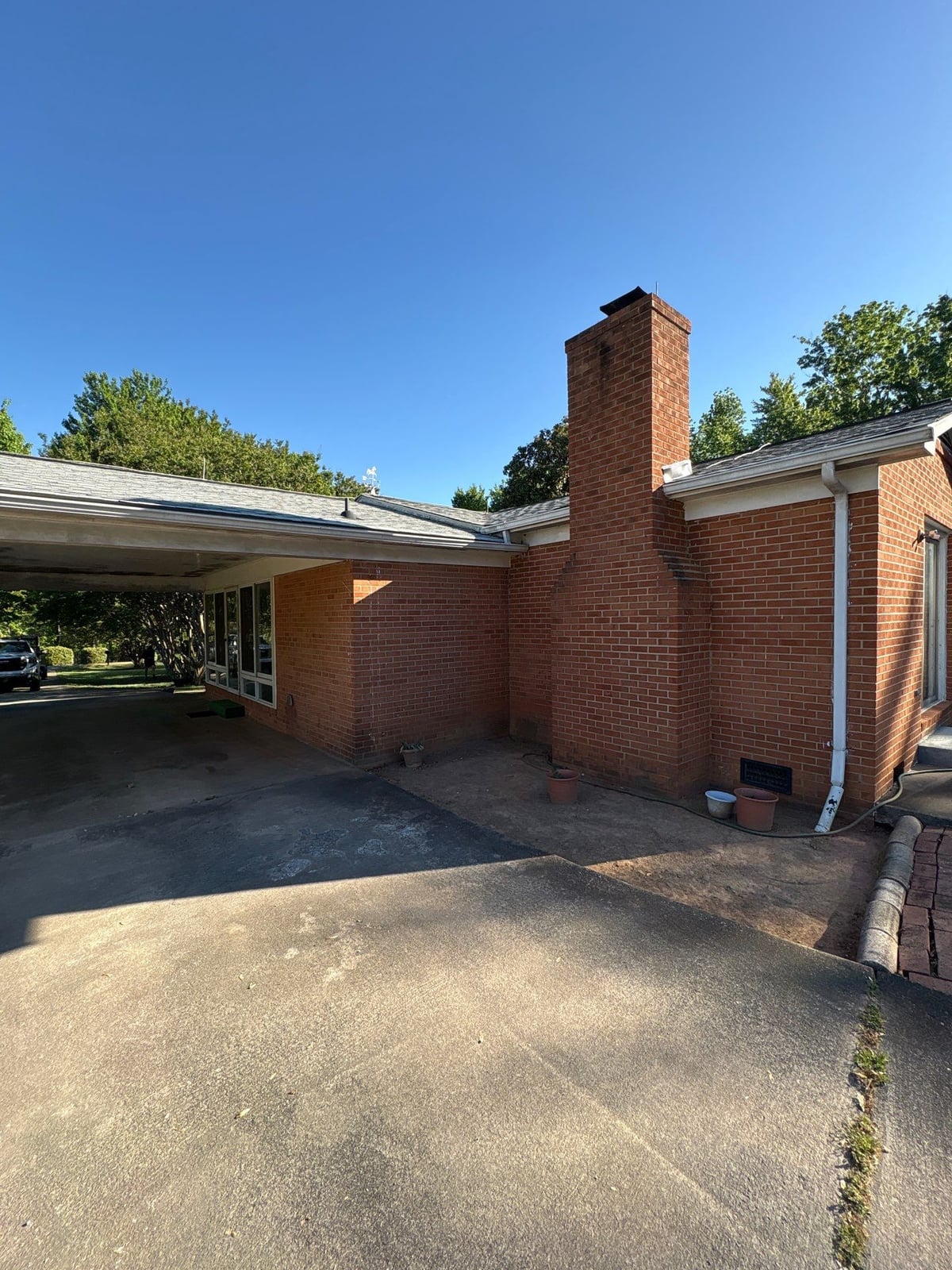 Exterior carport ceiling and concrete driveway pressure washing