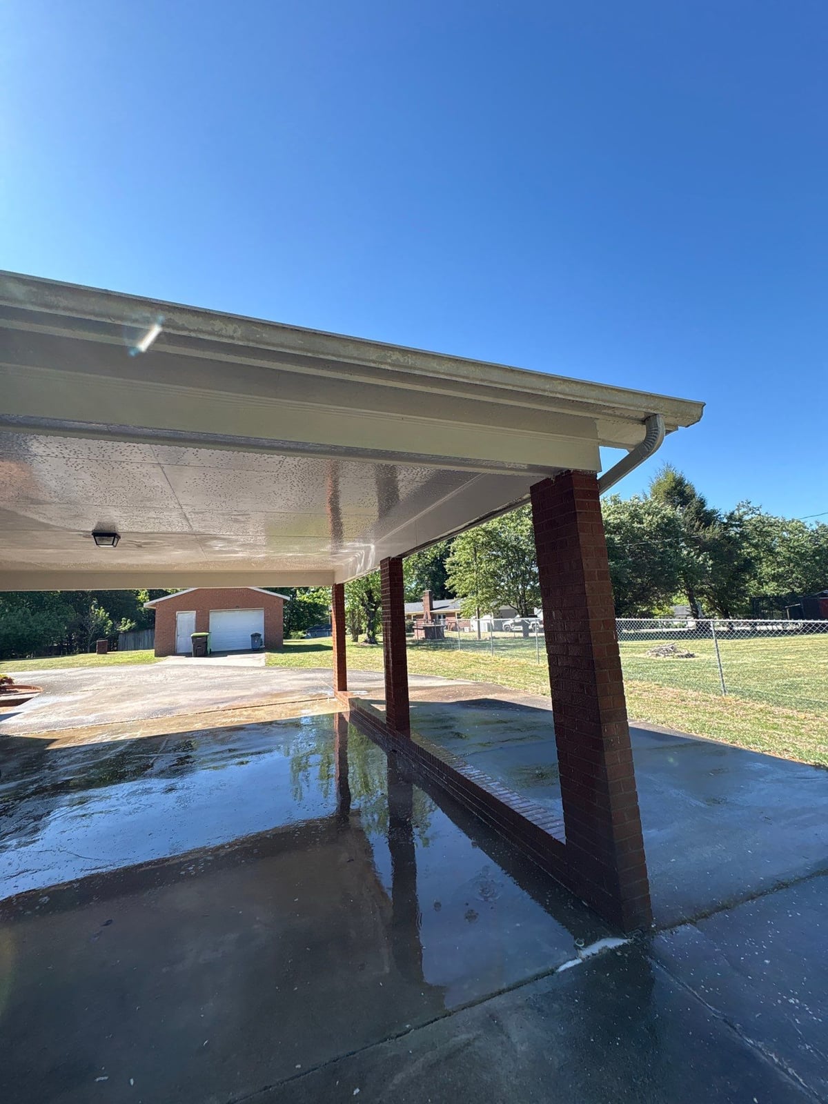 Exterior carport ceiling and concrete driveway pressure washing