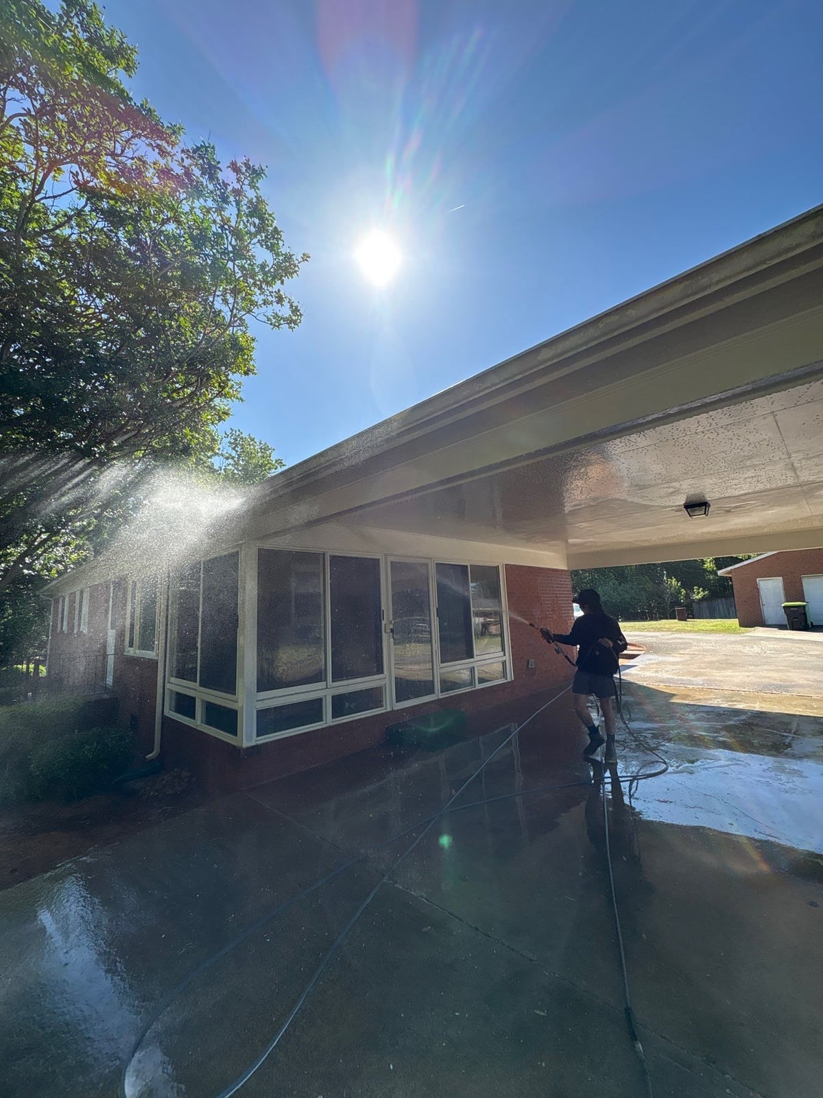 Exterior carport ceiling and concrete driveway pressure washing