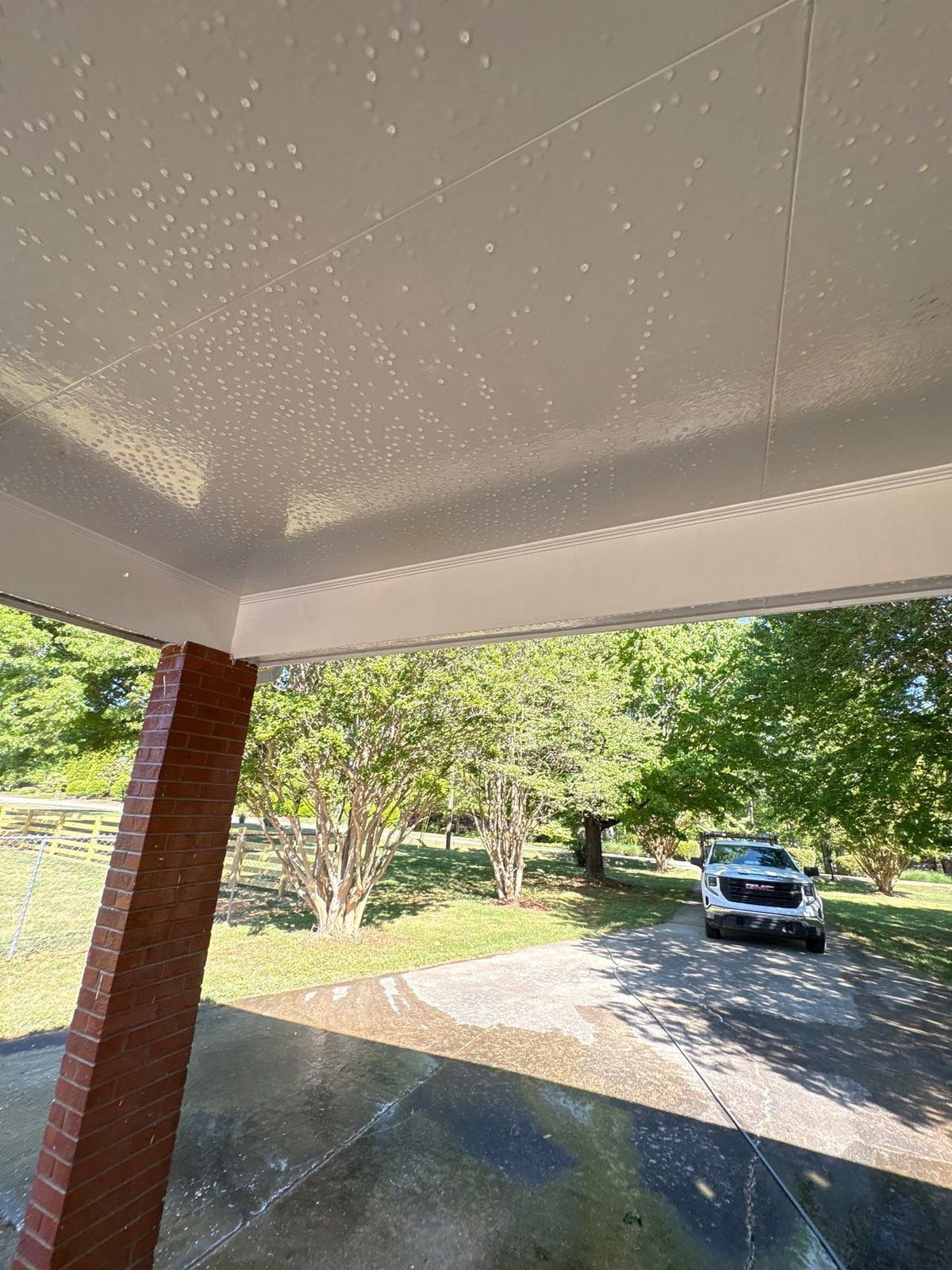 Exterior carport ceiling and concrete driveway pressure washing