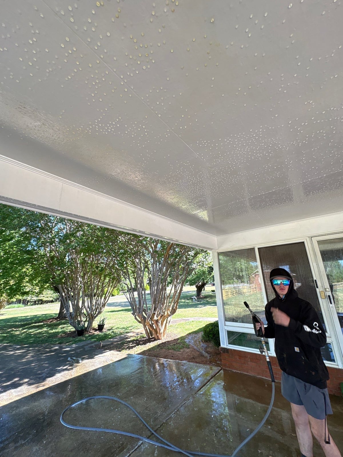 Exterior carport ceiling and concrete driveway pressure washing