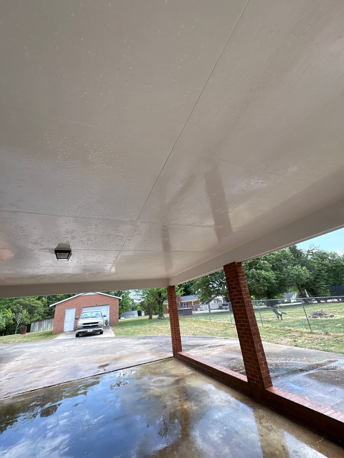 Exterior carport ceiling and concrete driveway pressure washing