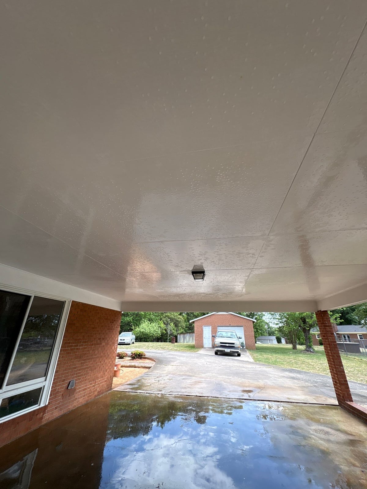 Exterior carport ceiling and concrete driveway pressure washing