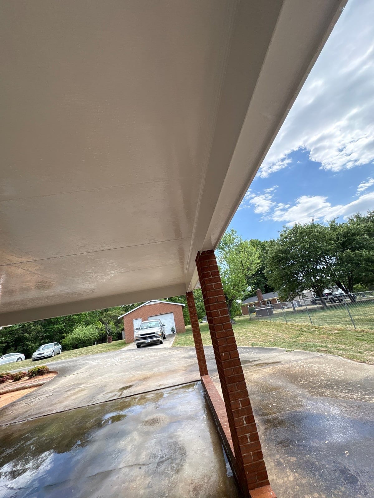 Exterior carport ceiling and concrete driveway pressure washing
