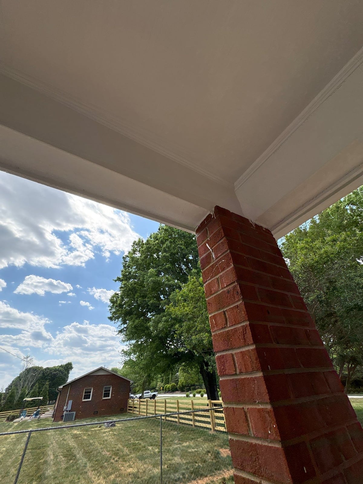 Exterior carport ceiling and concrete driveway pressure washing