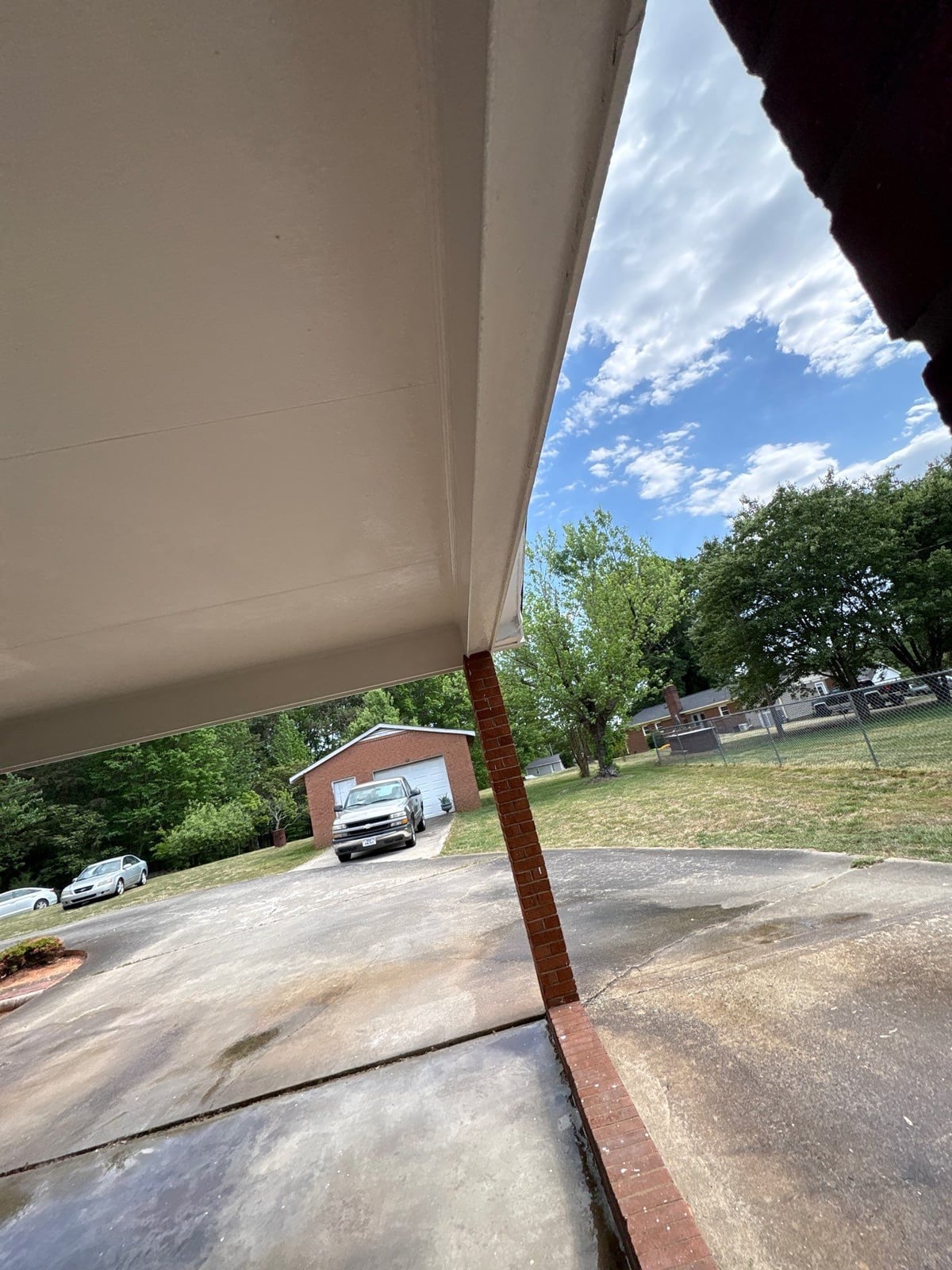 Exterior carport ceiling and concrete driveway pressure washing