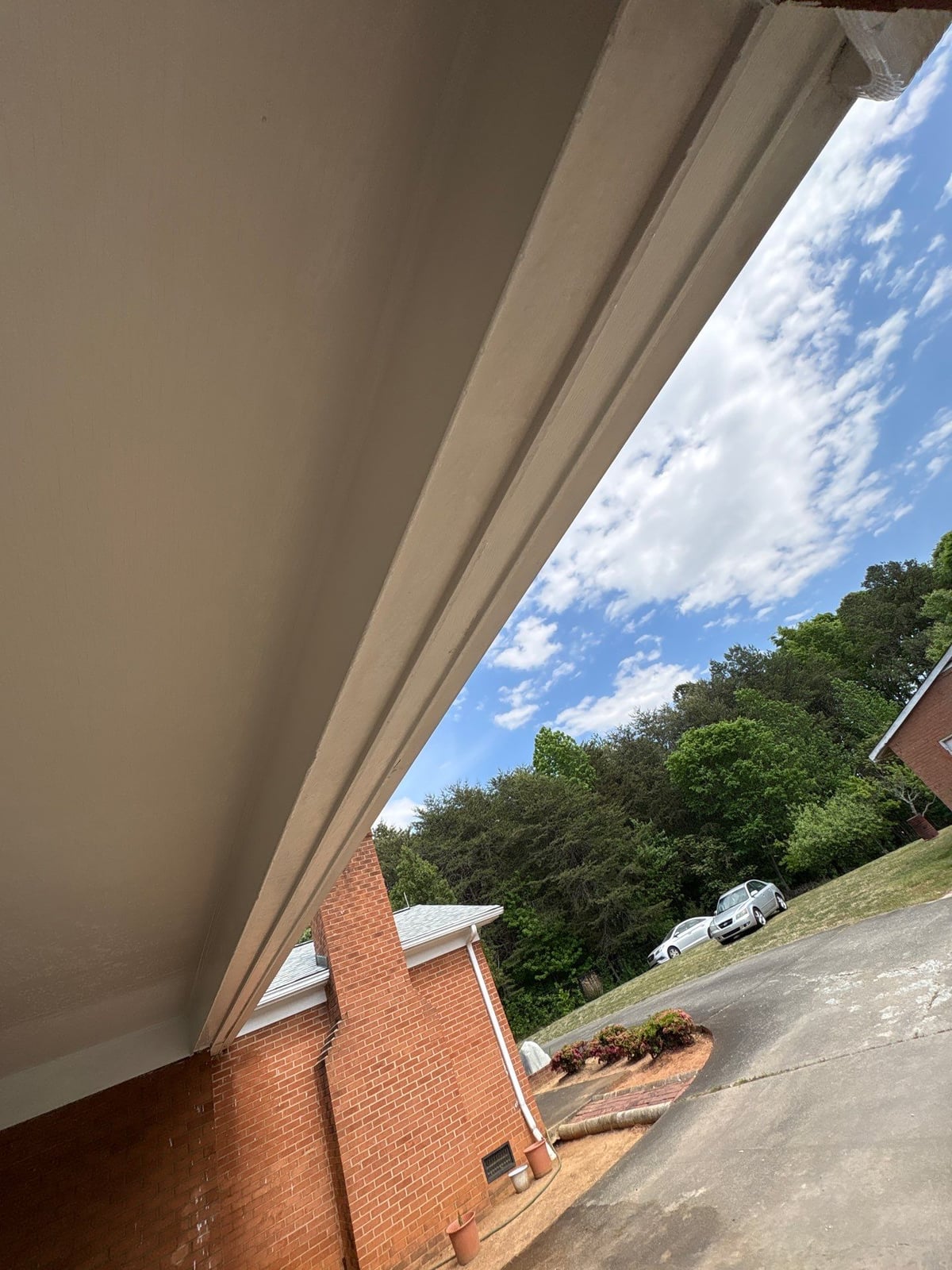 Exterior carport ceiling and concrete driveway pressure washing