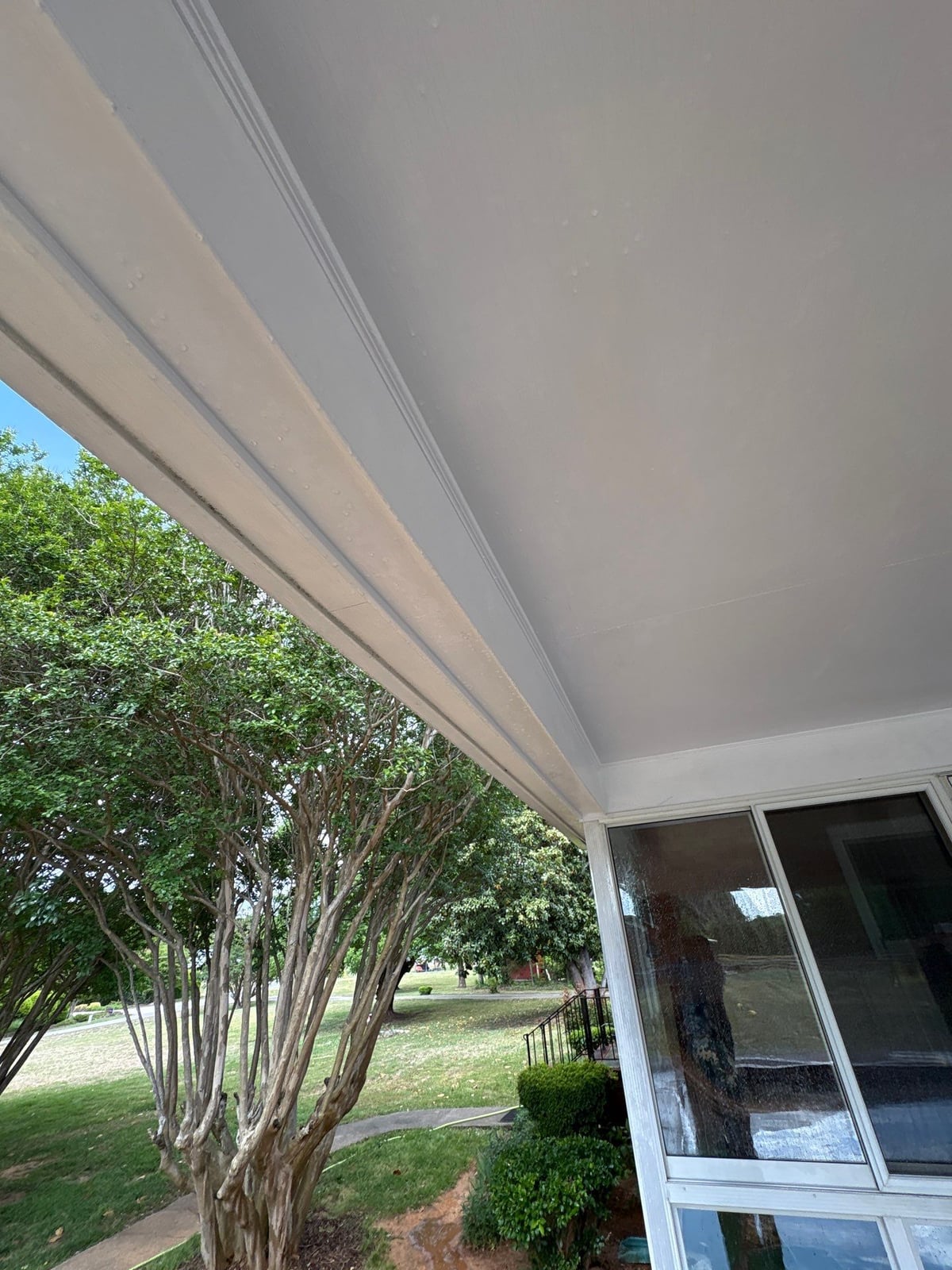 Exterior carport ceiling and concrete driveway pressure washing