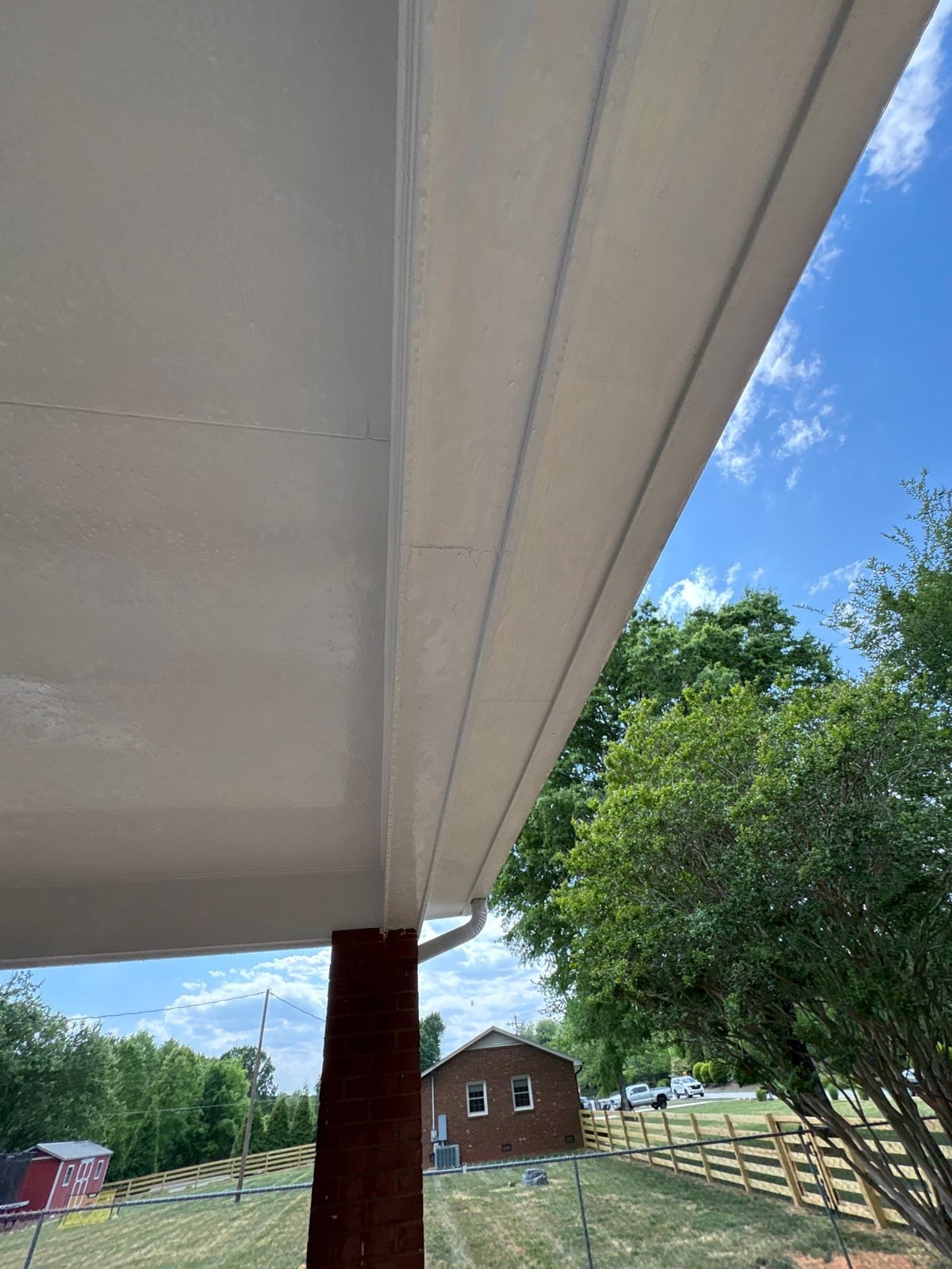 Exterior carport ceiling and concrete driveway pressure washing