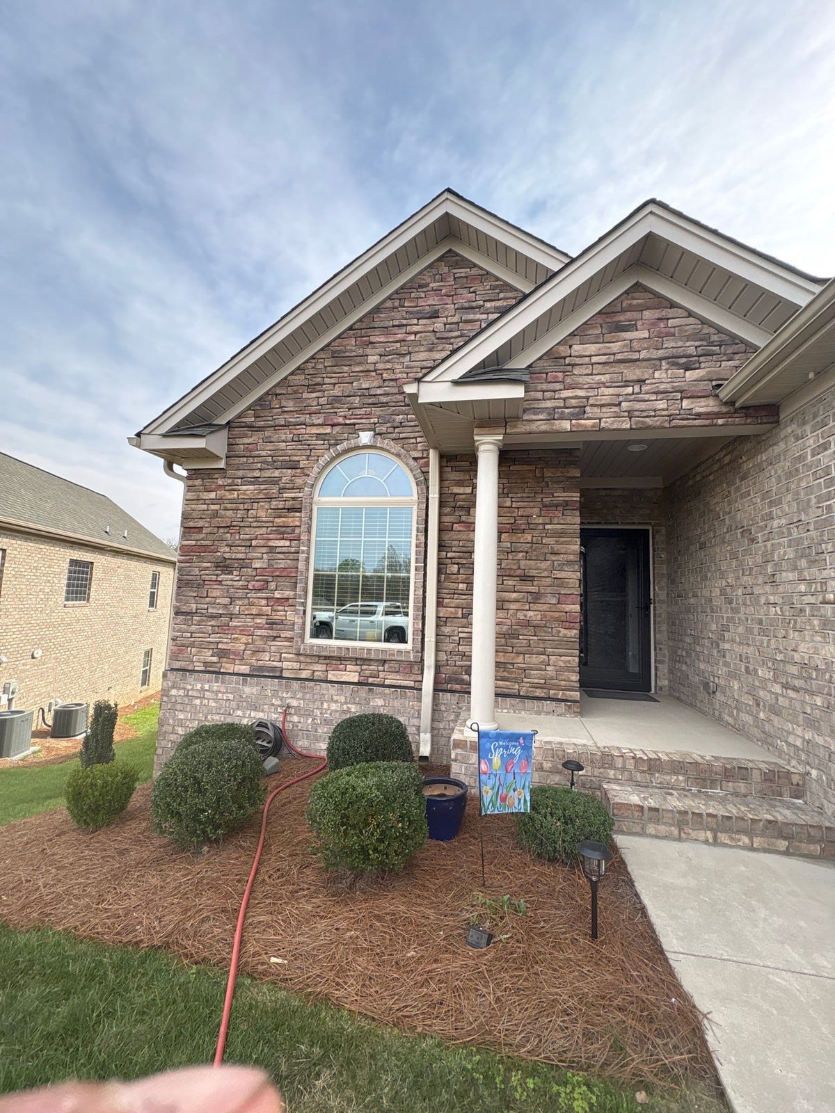 Exterior brick wall and garage door pressure washing