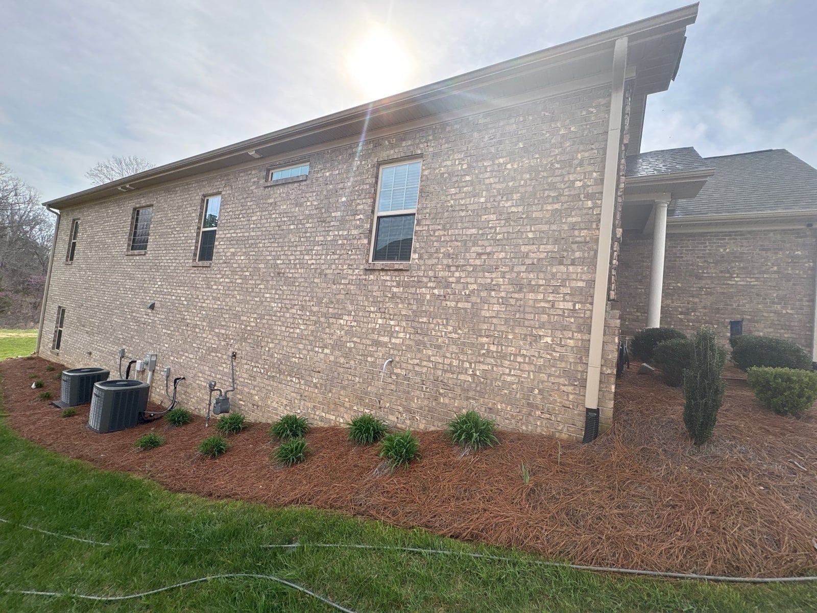 Exterior brick wall and garage door pressure washing