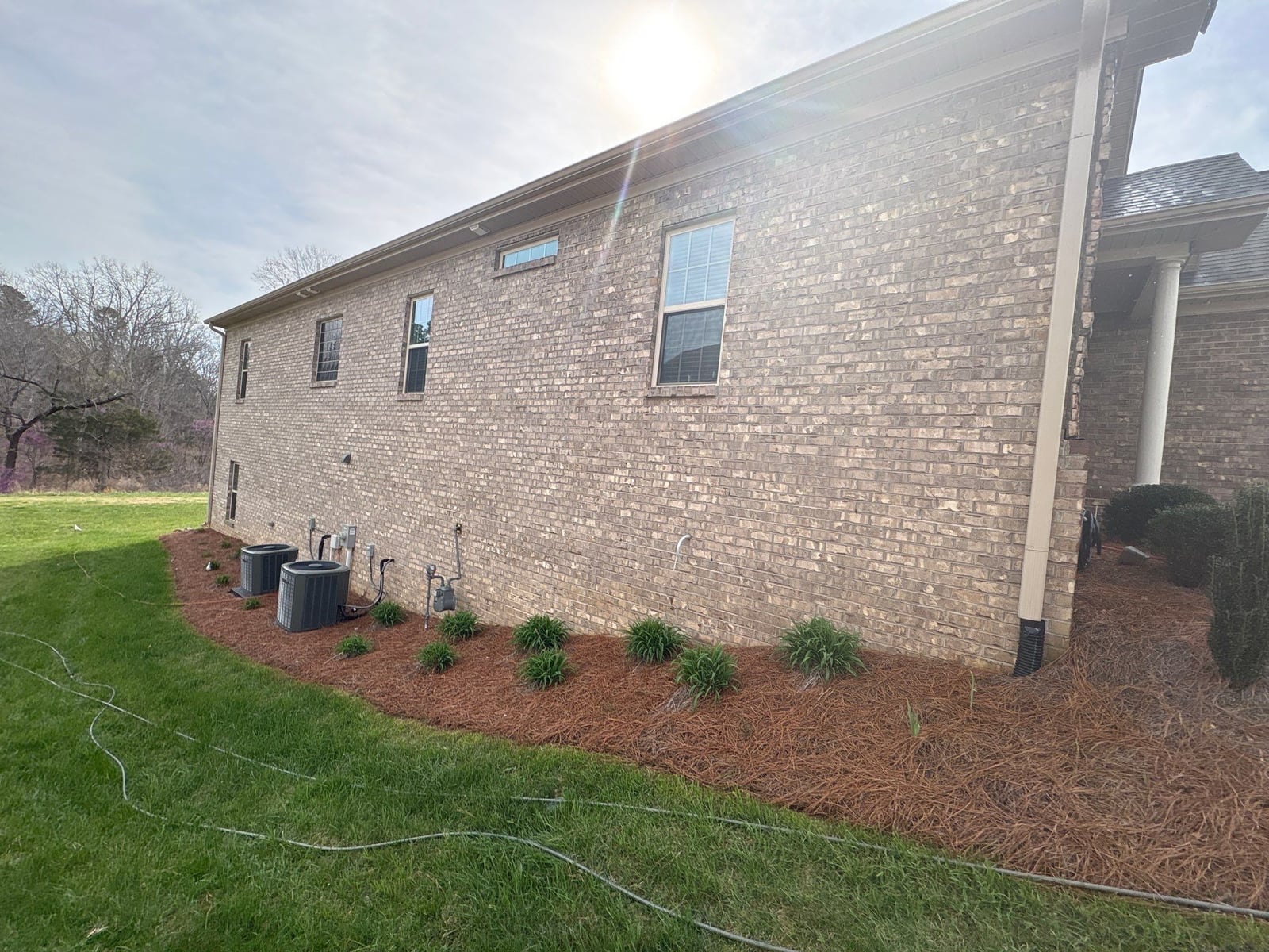 Exterior brick wall and garage door pressure washing