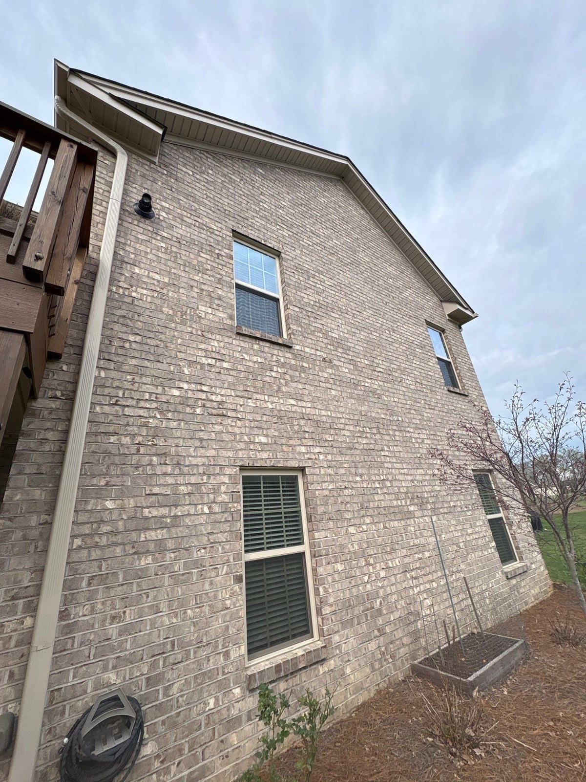Exterior brick wall and garage door pressure washing