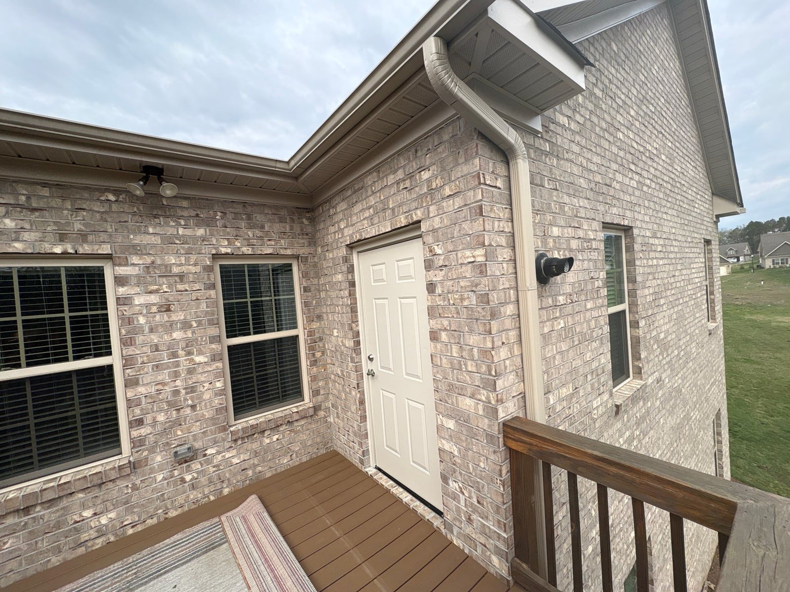Exterior brick wall and garage door pressure washing