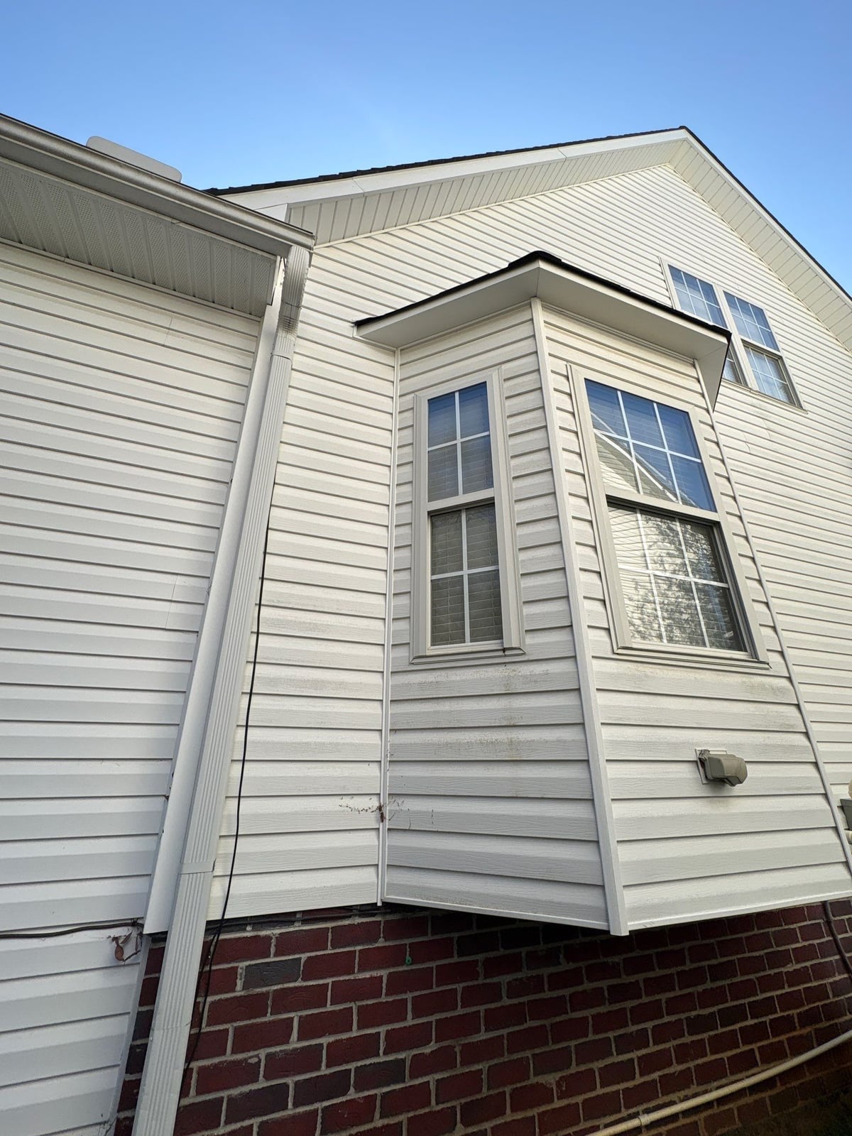Exterior soft washing of siding and wood deck railings