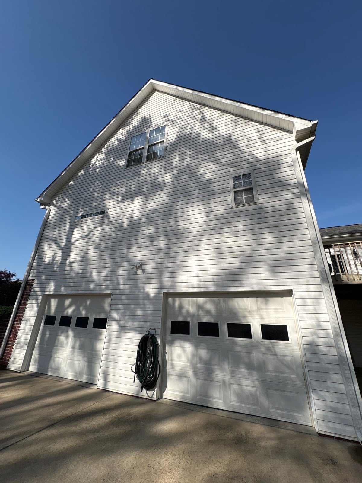 Exterior soft washing of siding and wood deck railings