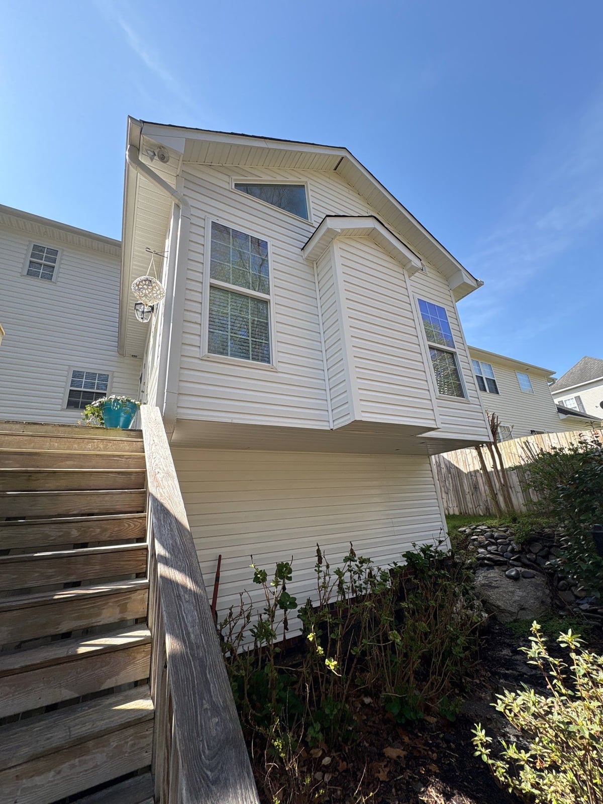 Exterior soft washing of siding and wood deck railings