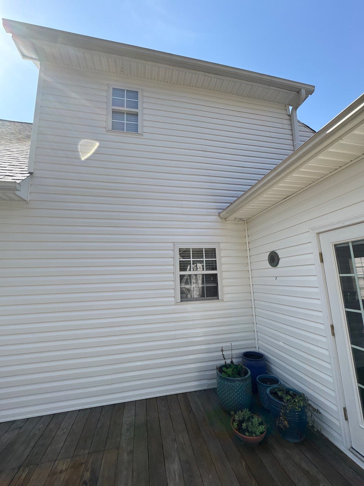 Exterior soft washing of siding and wood deck railings