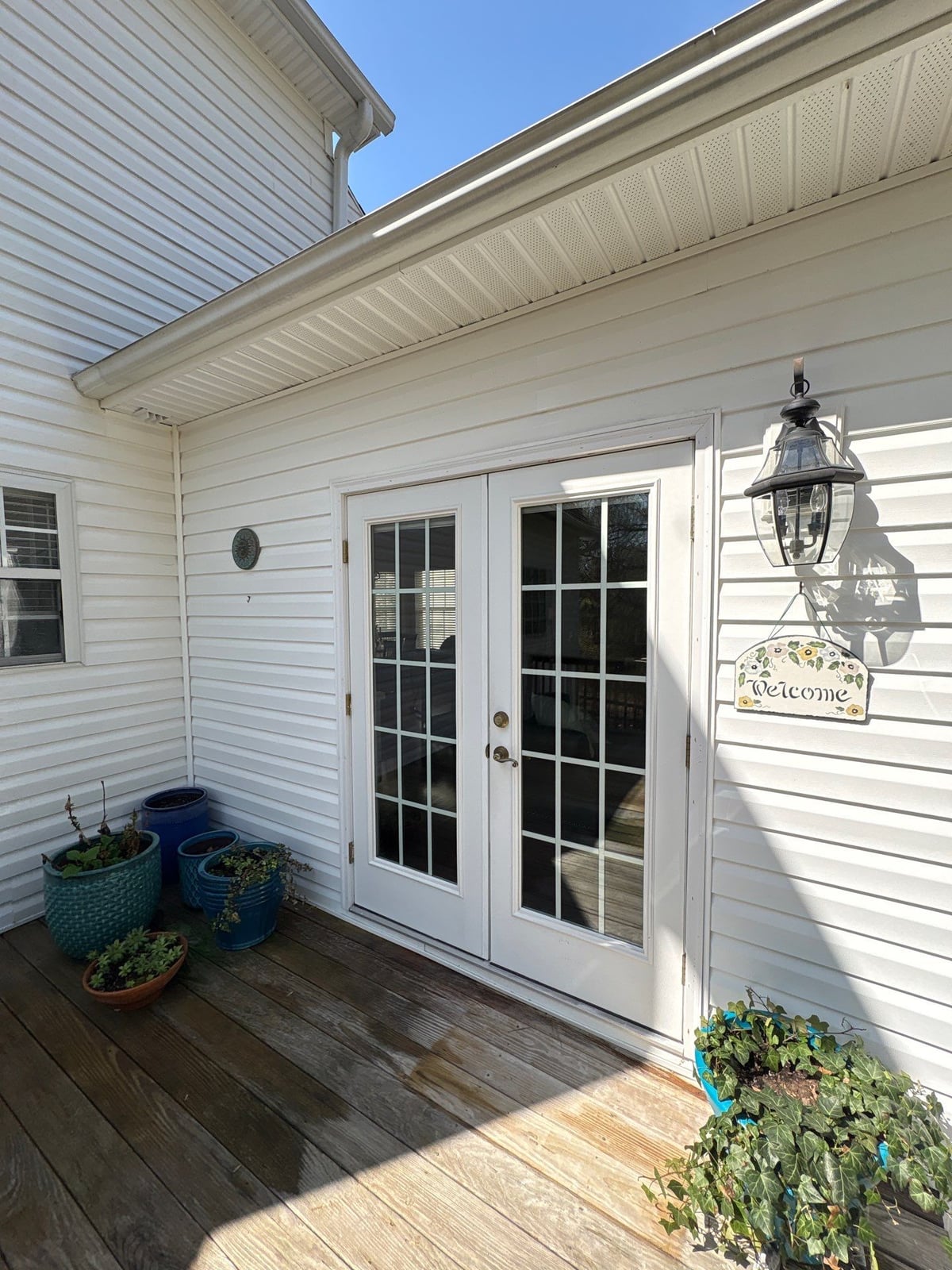 Exterior soft washing of siding and wood deck railings