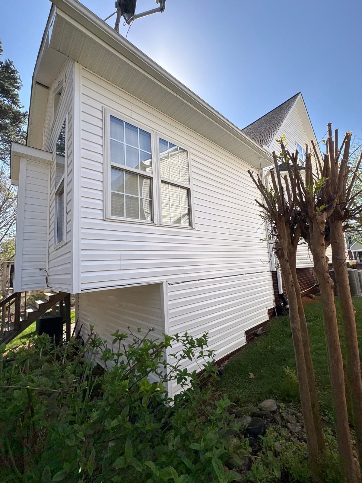 Exterior soft washing of siding and wood deck railings