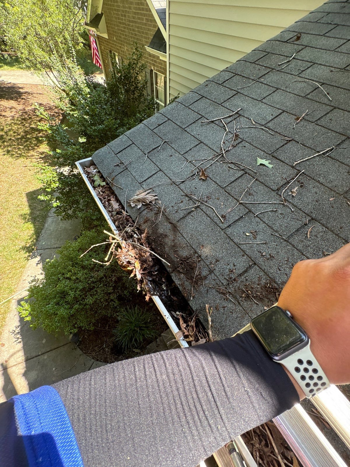 Clearing leaves and debris from house gutter system