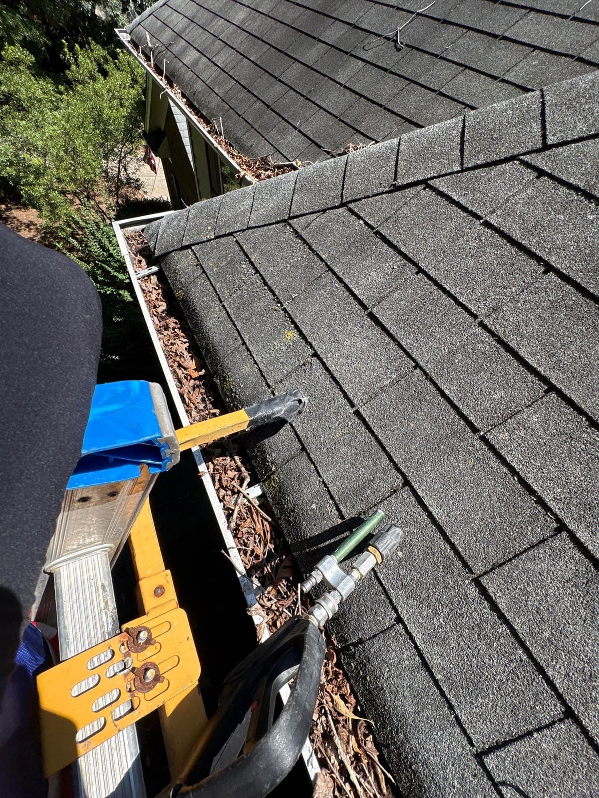 Clearing leaves and debris from house gutter system