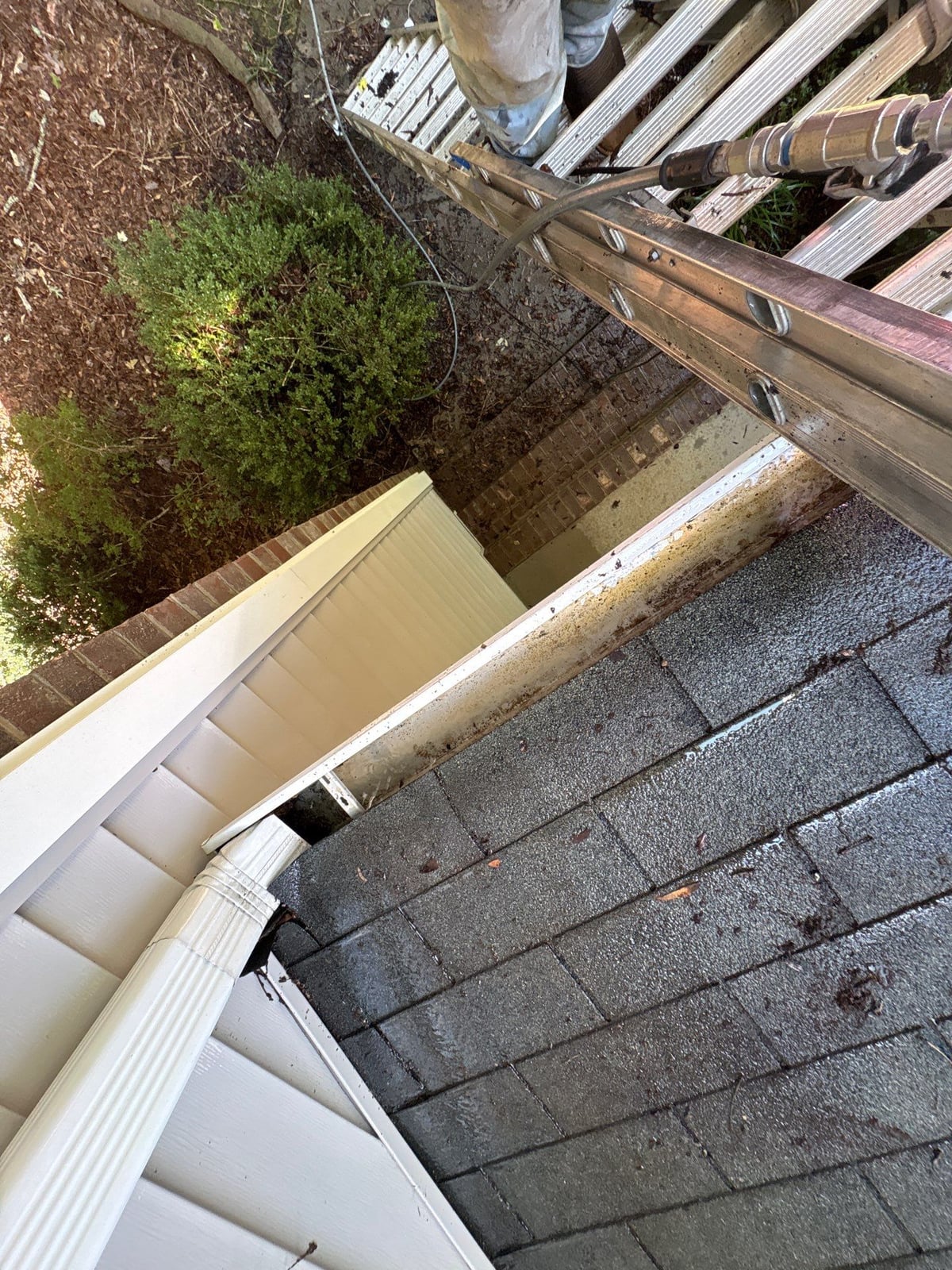 Clearing leaves and debris from house gutter system