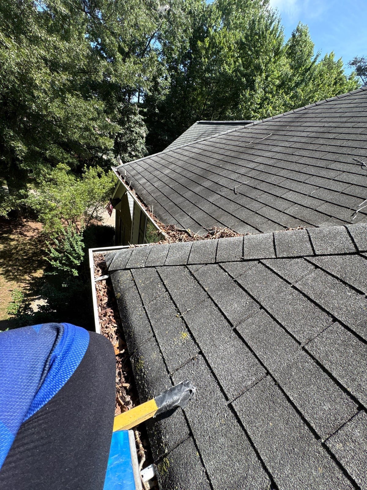 Clearing leaves and debris from house gutter system