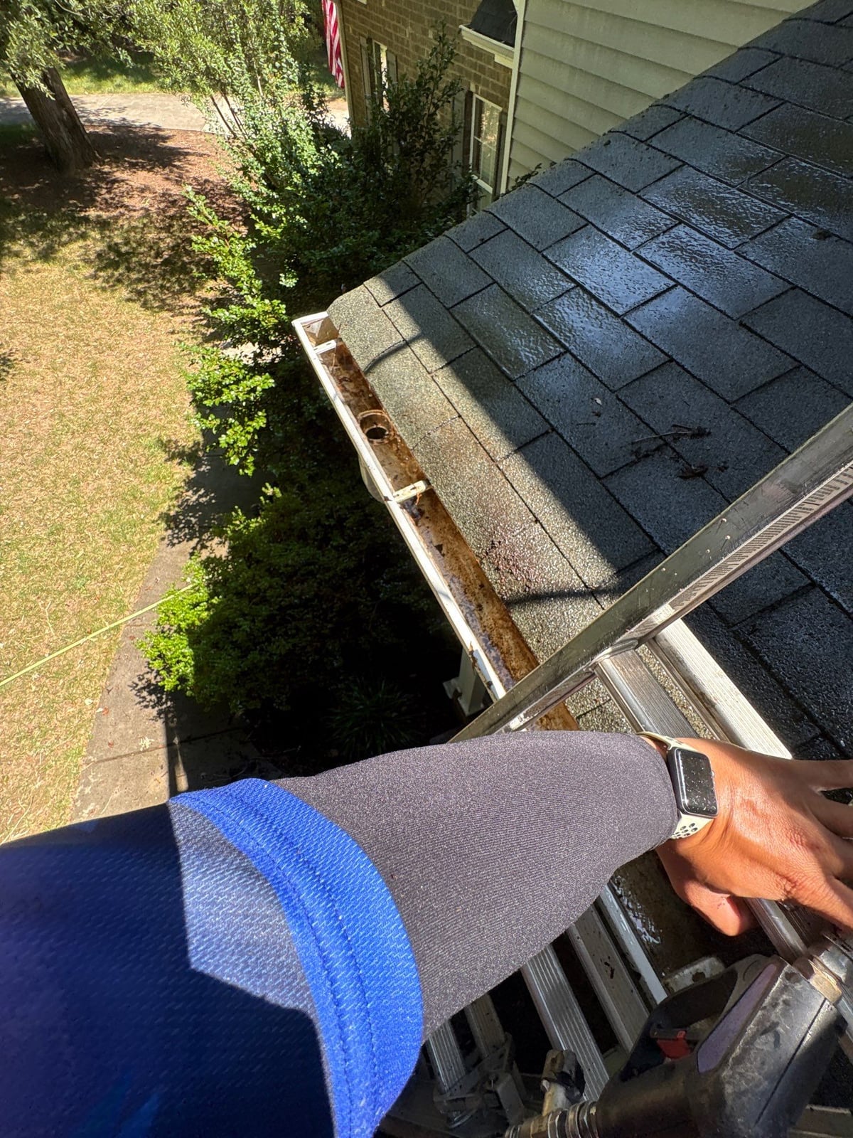 Clearing leaves and debris from house gutter system
