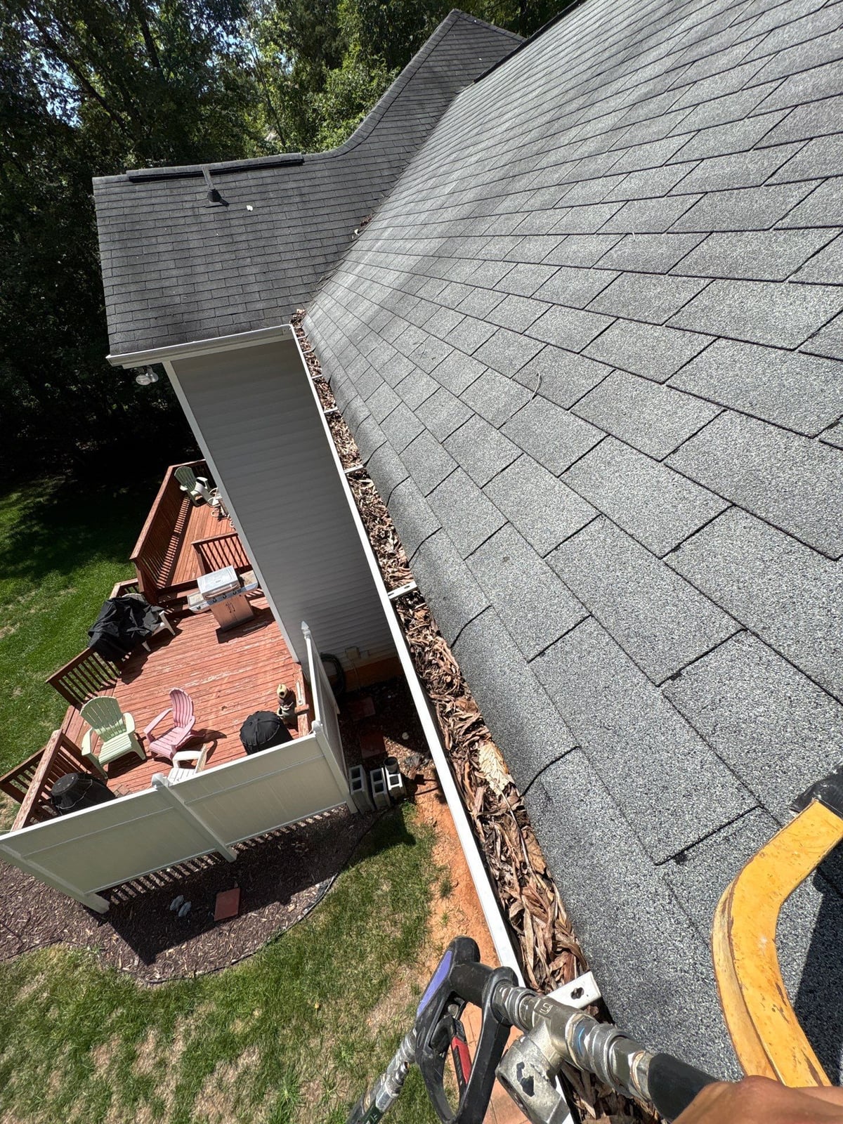 Clearing leaves and debris from house gutter system