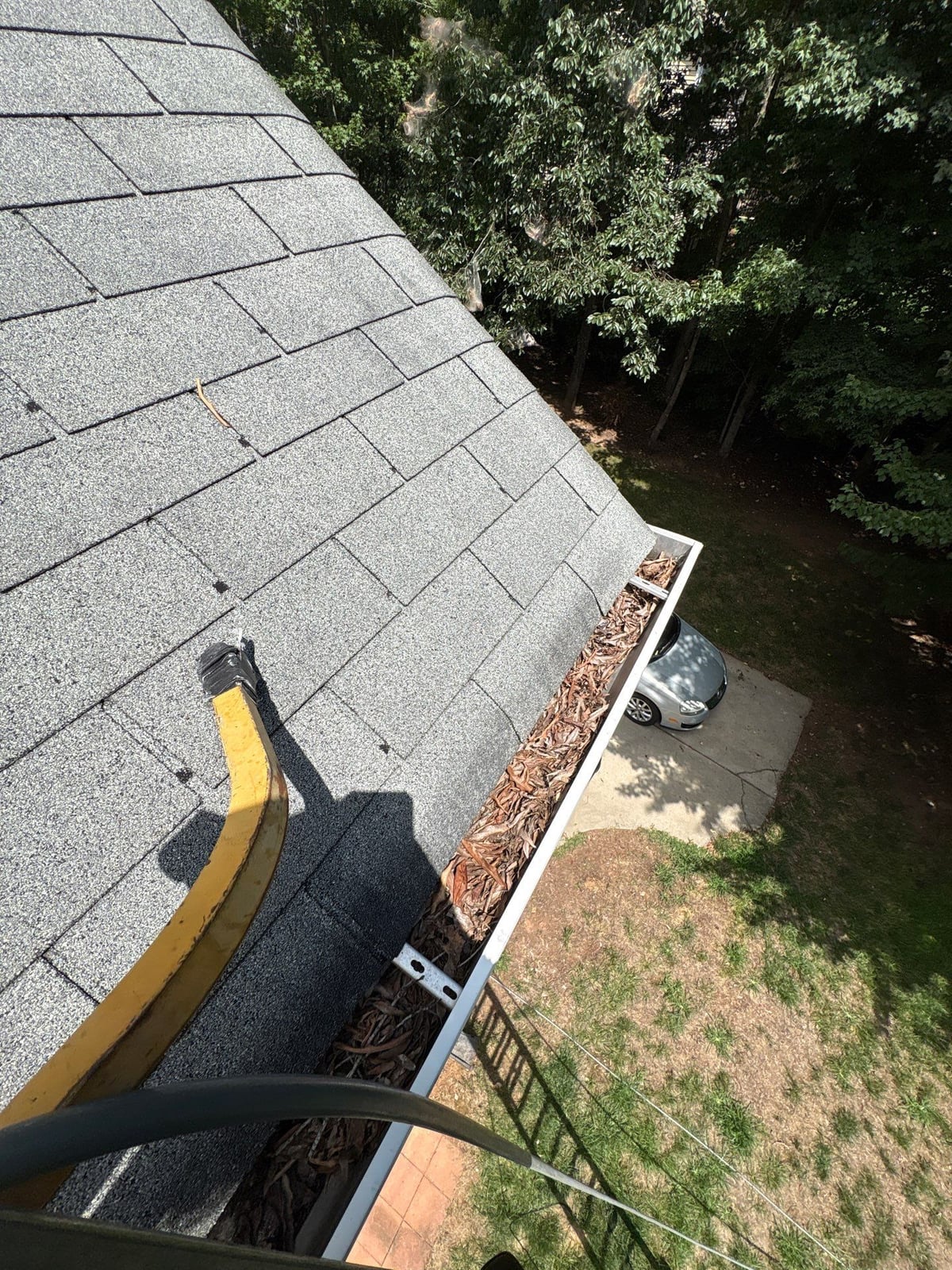 Clearing leaves and debris from house gutter system