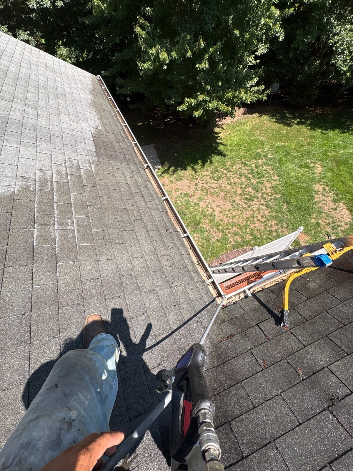 Clearing leaves and debris from house gutter system