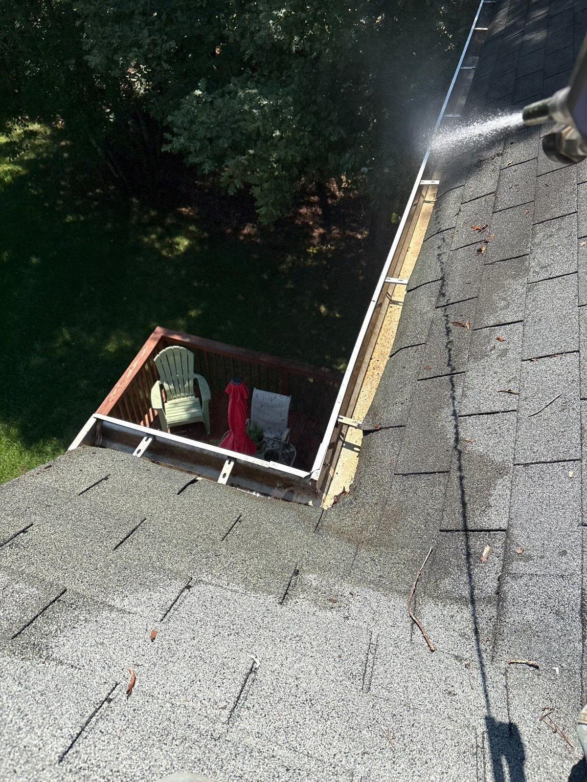 Clearing leaves and debris from house gutter system