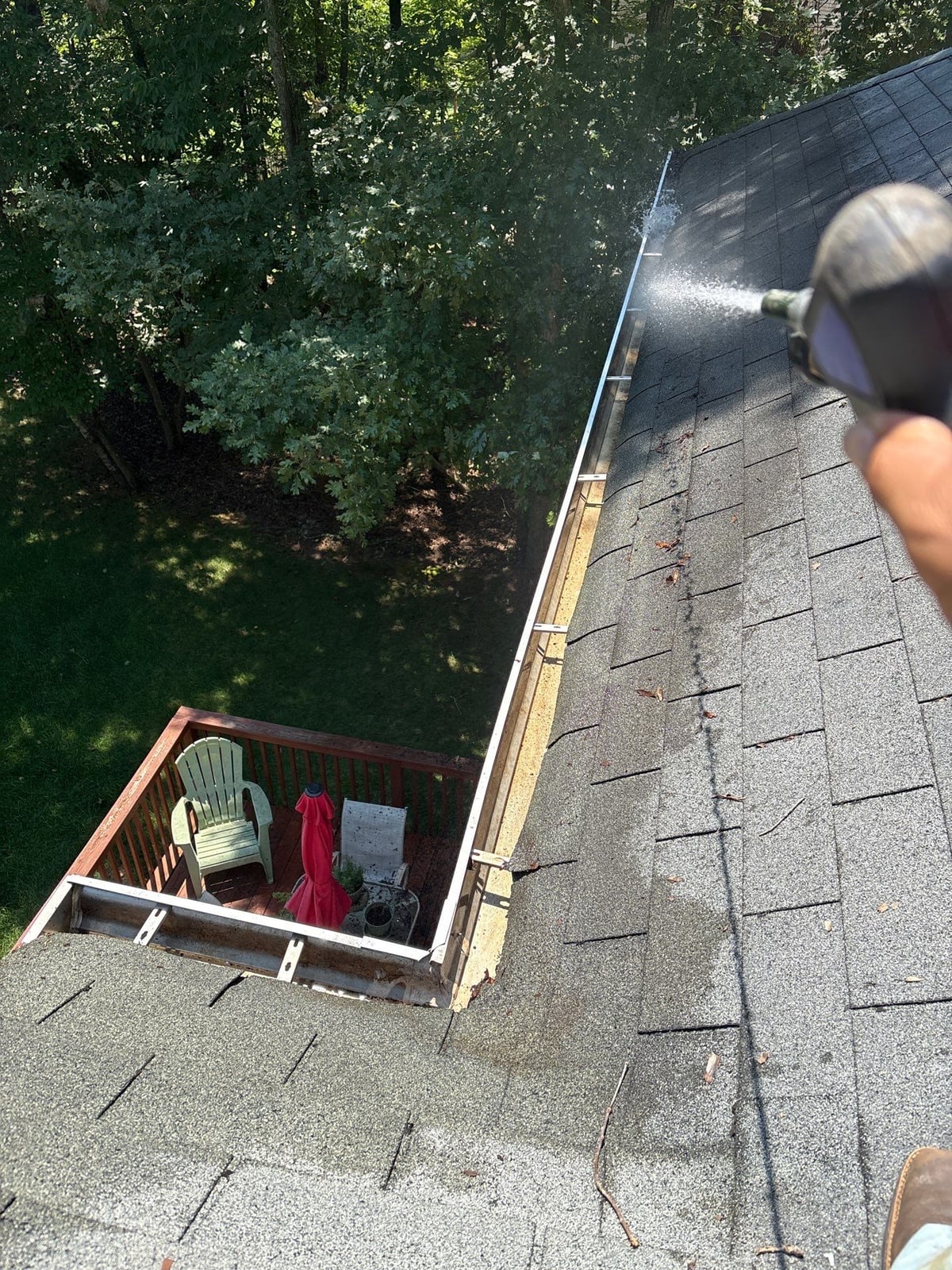 Clearing leaves and debris from house gutter system
