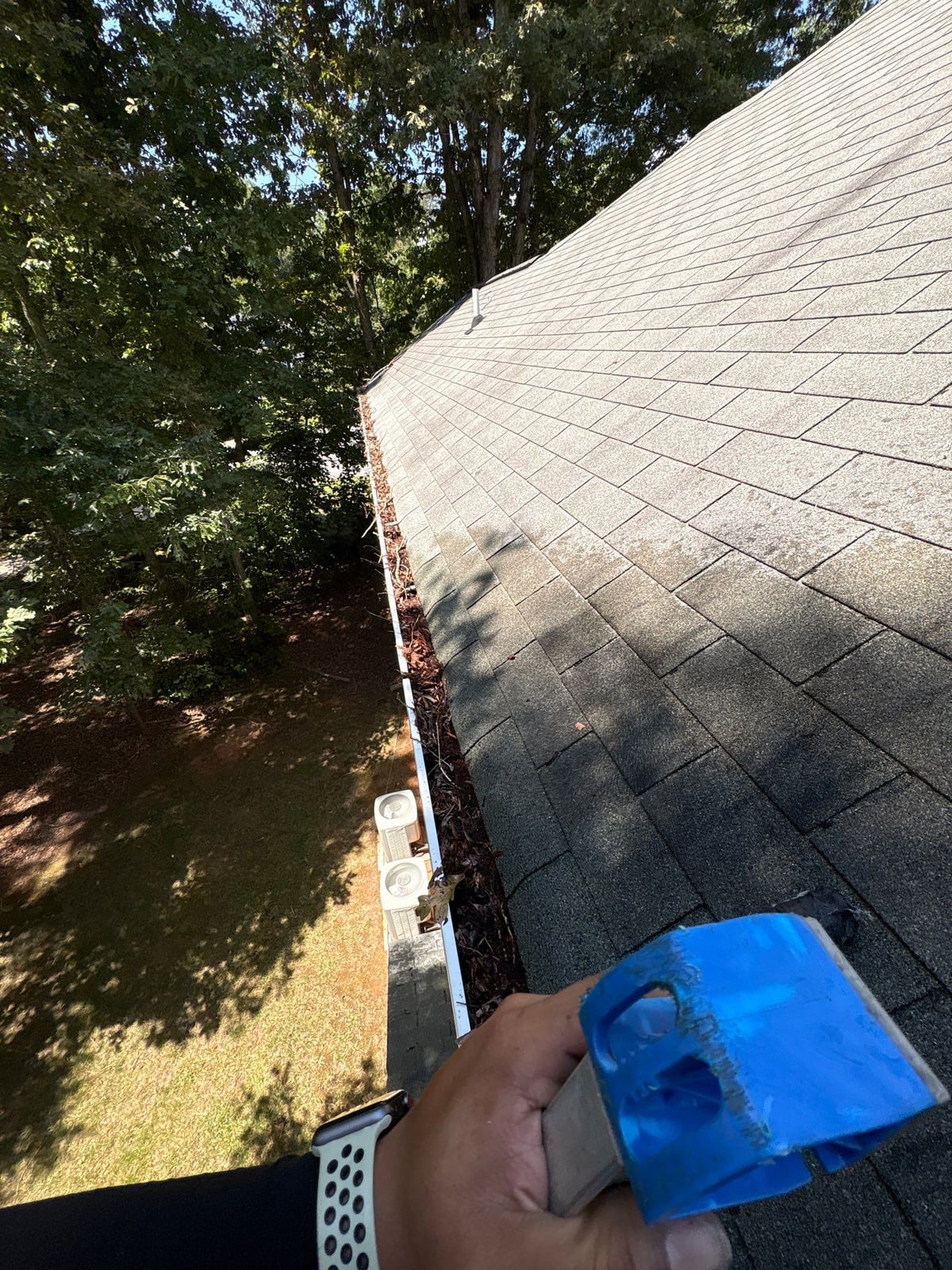 Clearing leaves and debris from house gutter system
