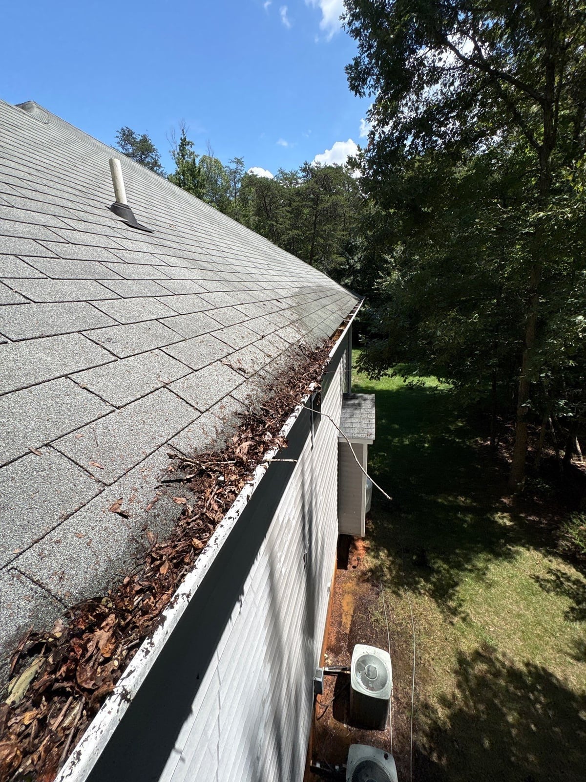 Clearing leaves and debris from house gutter system