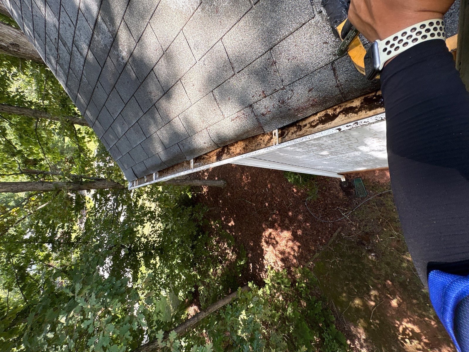 Clearing leaves and debris from house gutter system