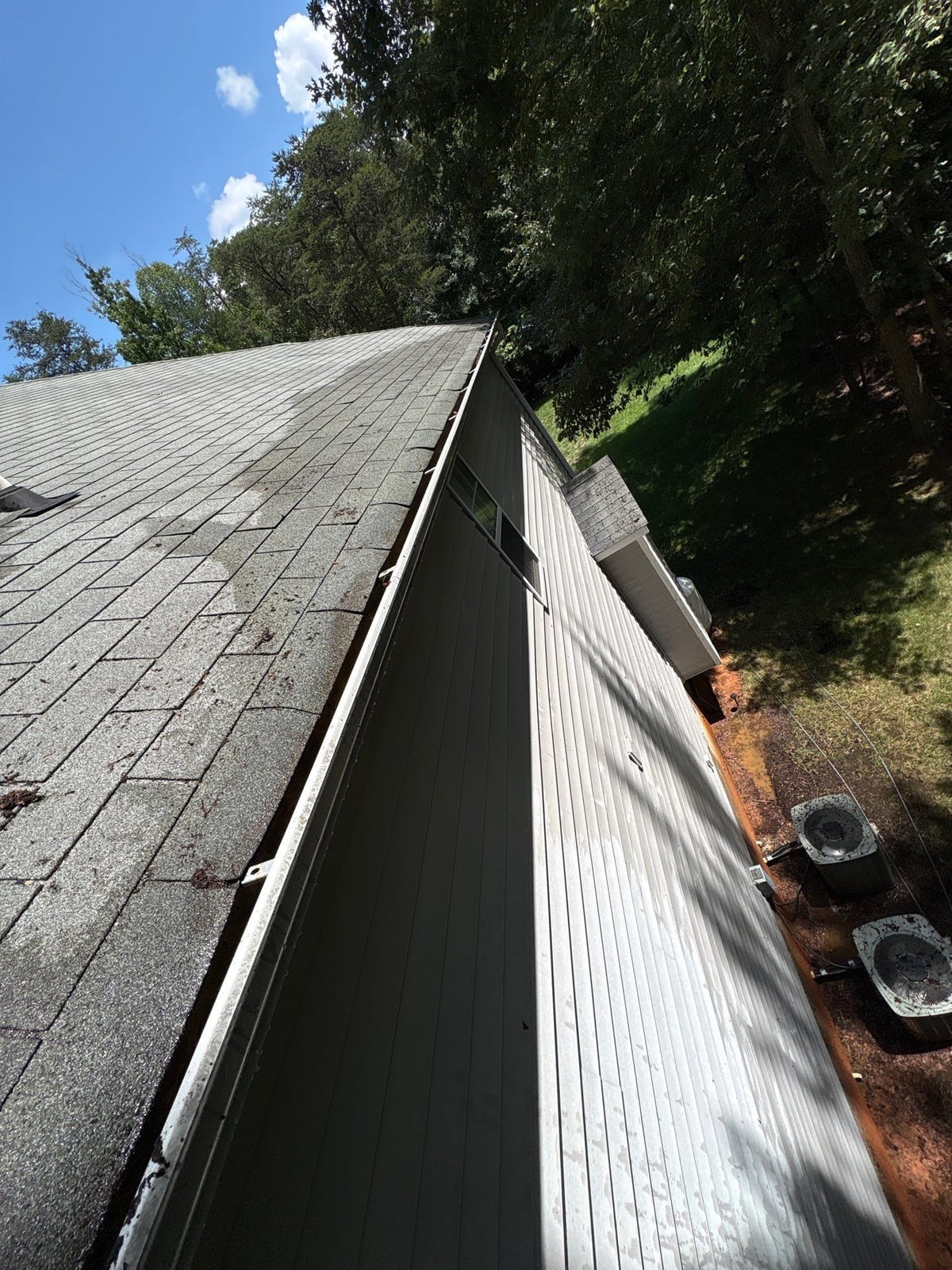 Clearing leaves and debris from house gutter system