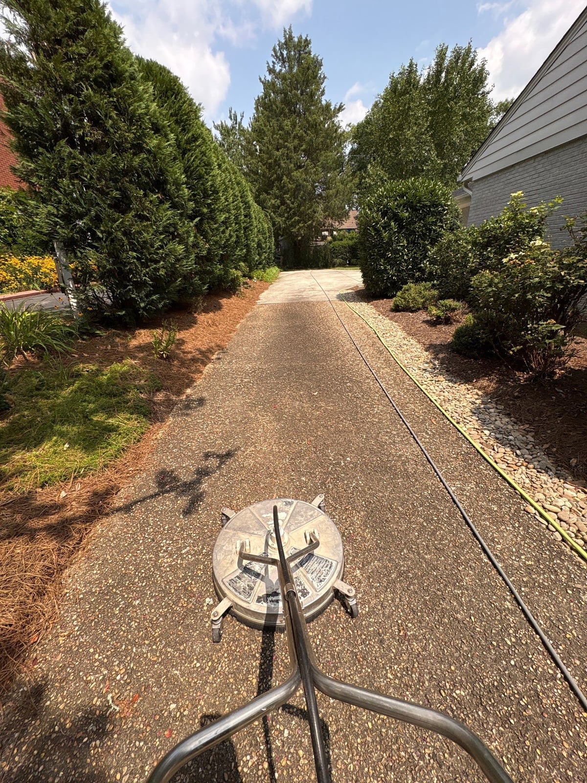 Pressure washing and surface cleaning of residential driveway