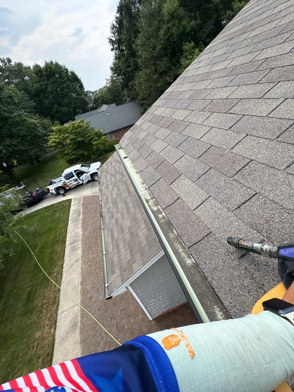 Roofline gutter debris removal and downspout flow inspection
