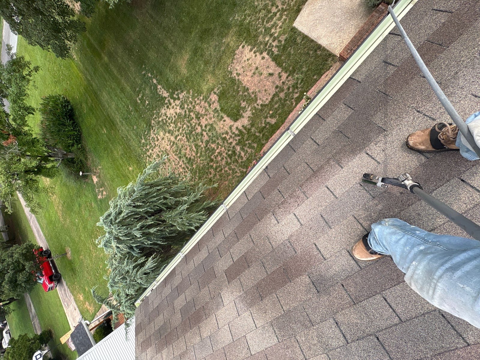 Roofline gutter debris removal and downspout flow inspection