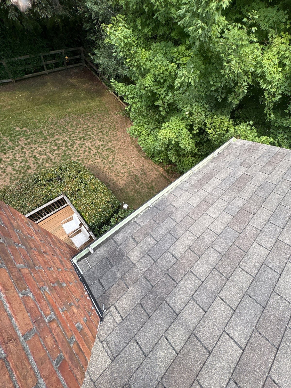 Roofline gutter debris removal and downspout flow inspection