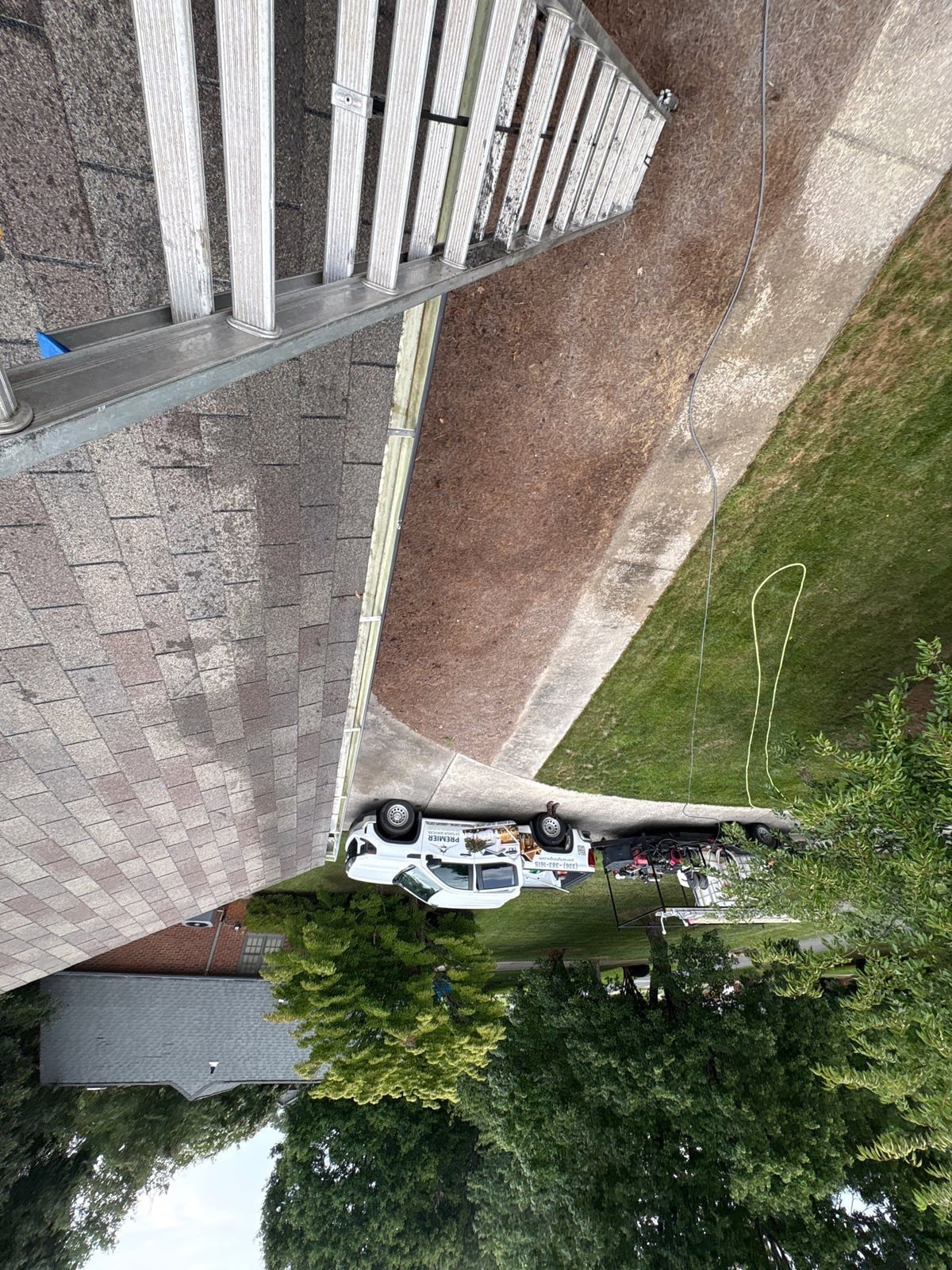 Roofline gutter debris removal and downspout flow inspection