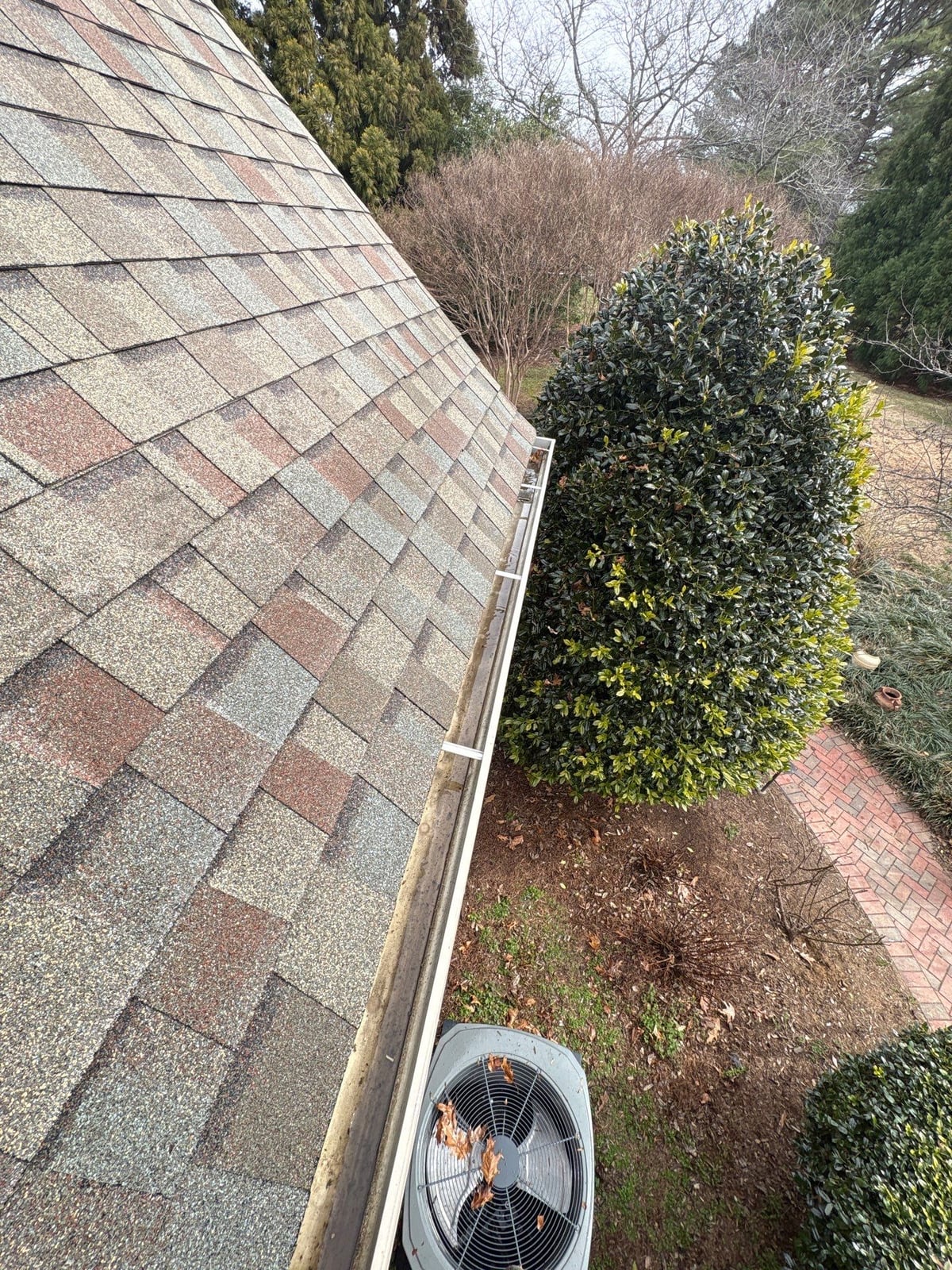 Exterior residential gutter cleaning and downspout debris removal