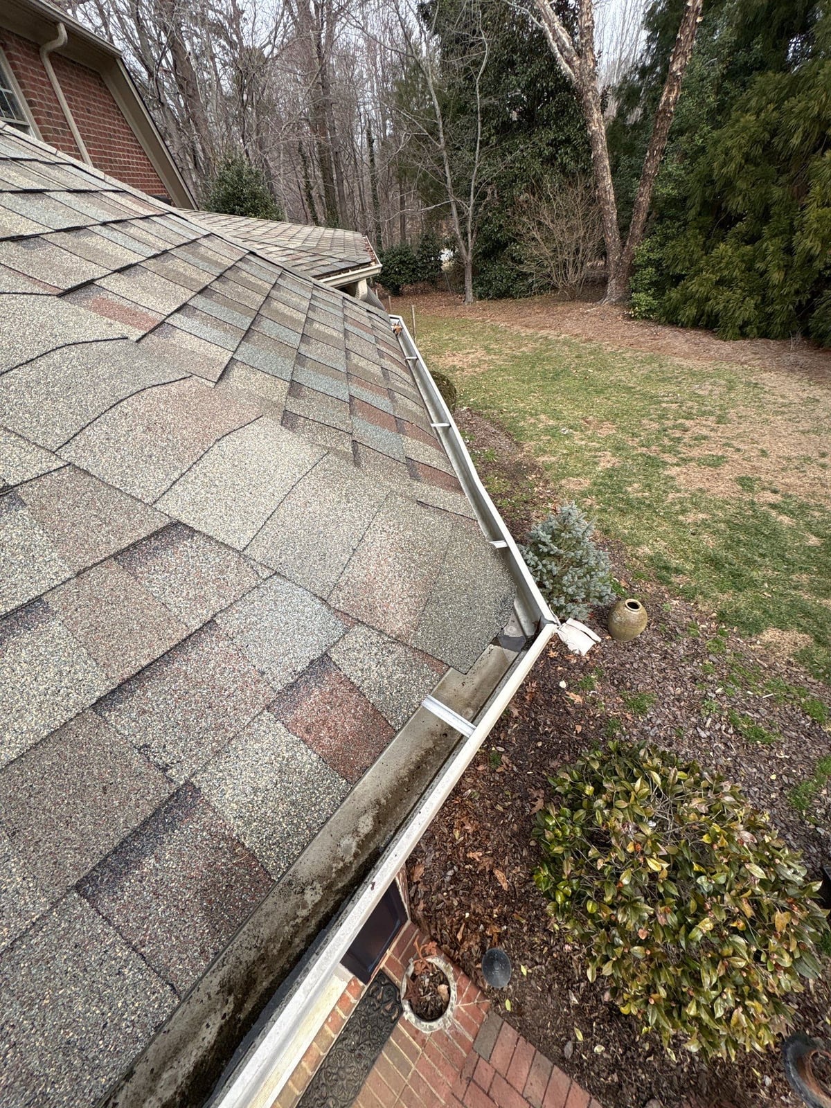 Exterior residential gutter cleaning and downspout debris removal
