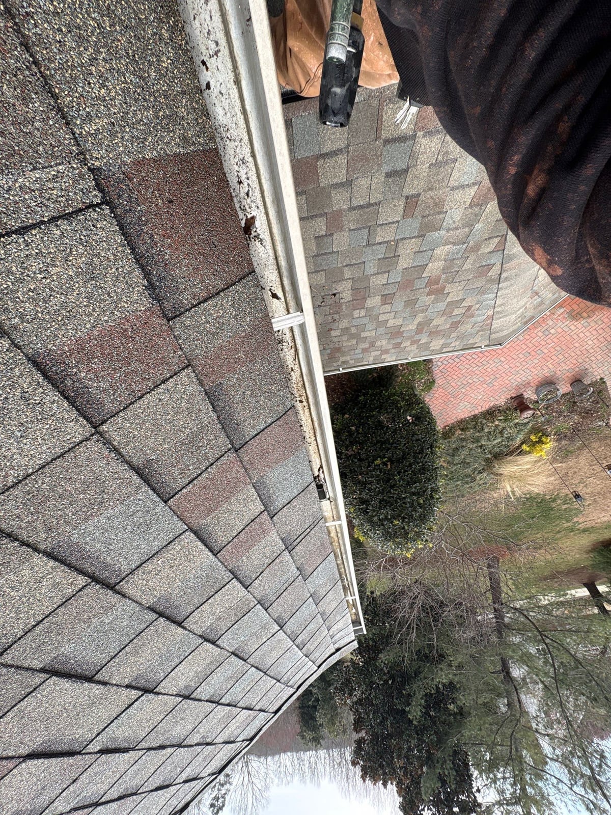 Exterior residential gutter cleaning and downspout debris removal