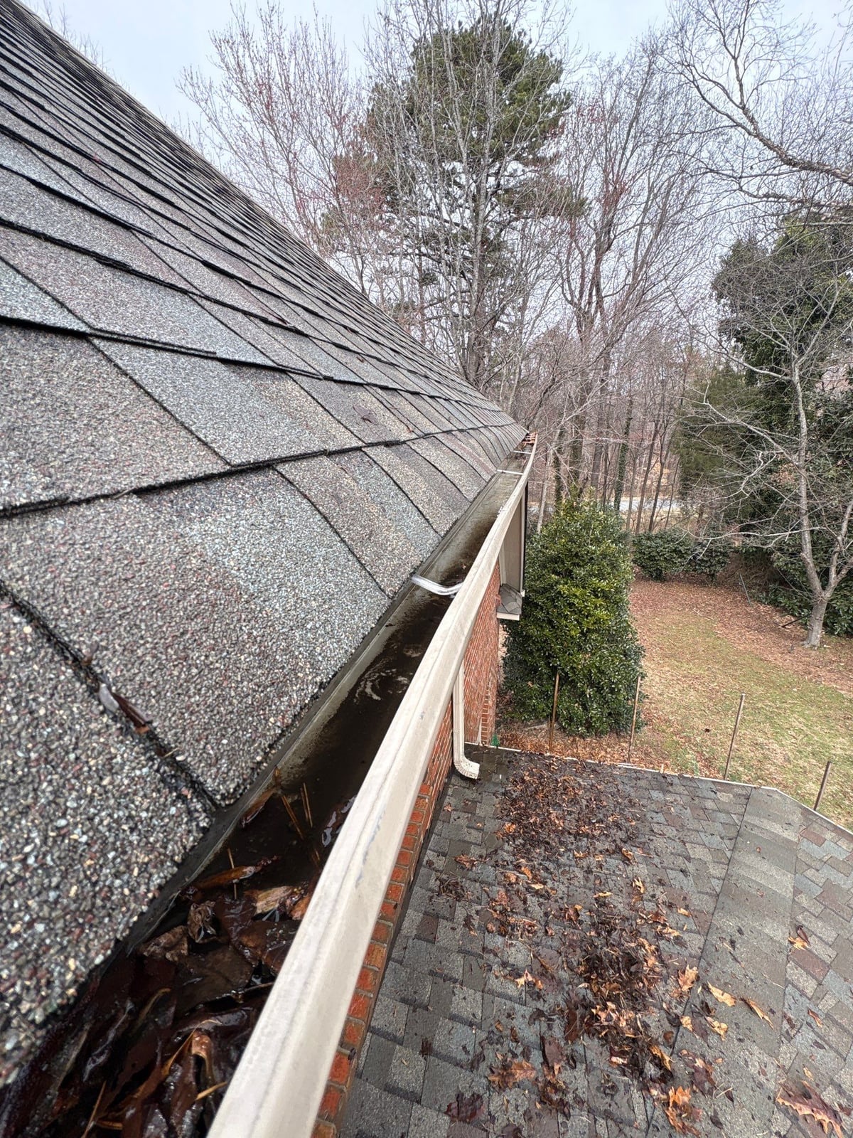 Exterior residential gutter cleaning and downspout debris removal