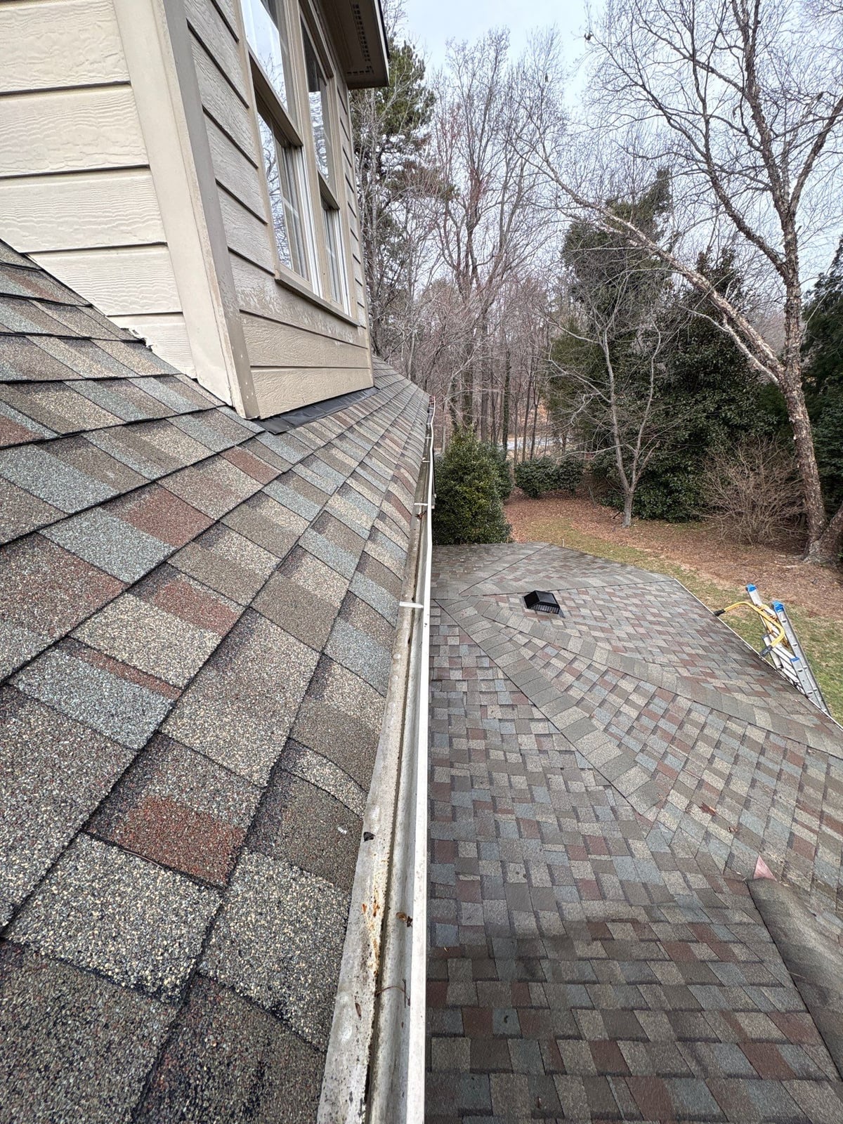 Exterior residential gutter cleaning and downspout debris removal