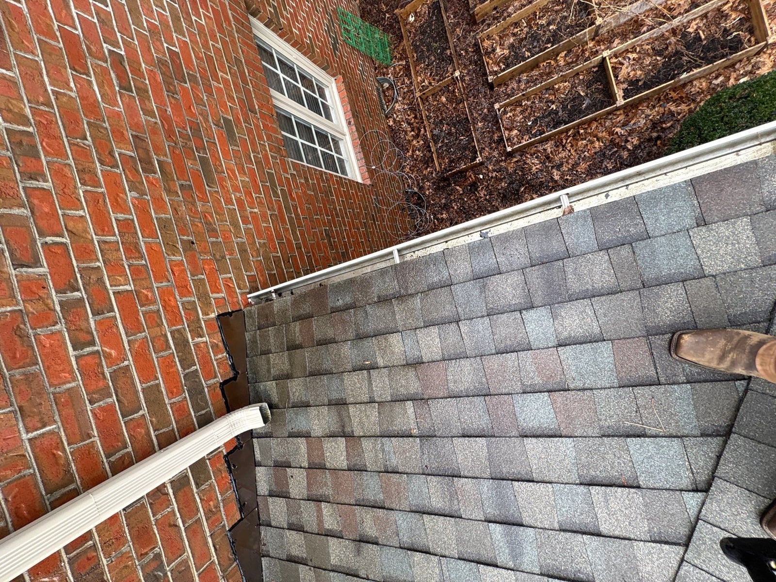 Exterior residential gutter cleaning and downspout debris removal